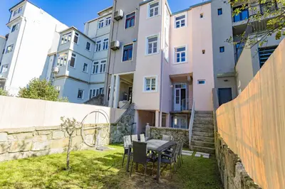 a table and chairs in front of a building at Alegria Rubi - Urban Oasis with Garden in Porto