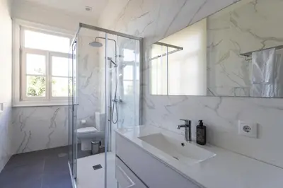 a bedroom with a bed and a desk and chairs at Alegria Rubi - Urban Oasis with Garden in Porto