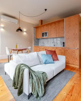 a living room with a white couch and a table at Visconde de Gandara Apartment by Porto Stories in Porto