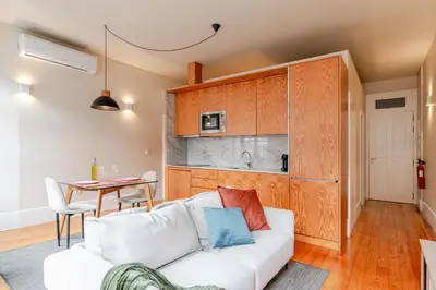 a living room with a white couch and a table at Visconde de Gandara Apartment by Porto Stories in Porto