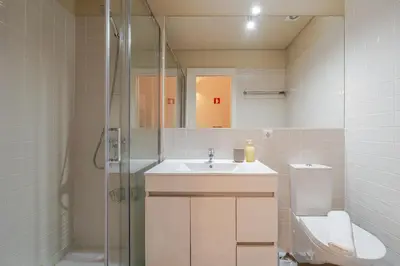 a bathroom with a sink and a shower and a toilet at Visconde de Gandara Apartment by Porto Stories in Porto