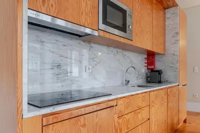 a kitchen with a sink and a microwave at Visconde de Gandara Apartment by Porto Stories in Porto