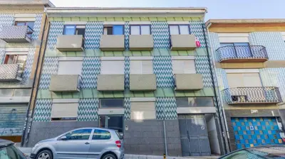 a car parked in front of a building with balconies at Porto Essence Apartment in Porto