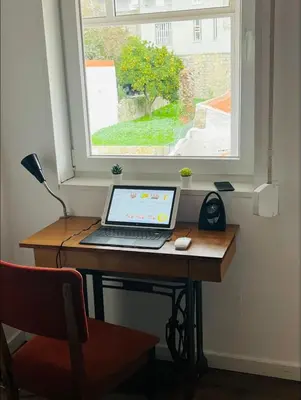 a laptop computer sitting on a desk in front of a window at Apartamento centro histórico Porto in Porto