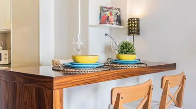 a dining room table with two bowls and two chairs at Adorable apartment 2D in Porto