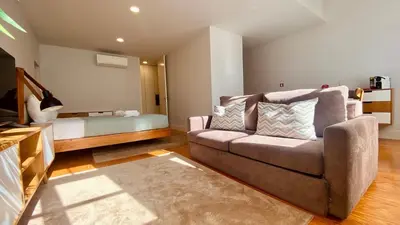 a living room with a couch and a bed at SM Apartments in Porto