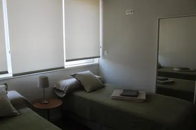 a bedroom with two beds and a mirror at My Oporto Apartment in Porto
