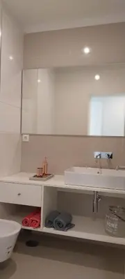 a white bathroom with a sink and a mirror at My Oporto Apartment in Porto