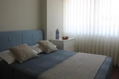 a bedroom with a blue bed and a window at My Oporto Apartment in Porto