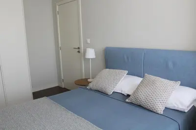 a blue bed with two pillows in a bedroom at My Oporto Apartment in Porto