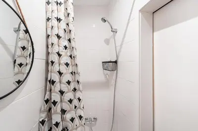a shower with a shower curtain in a bathroom at GuestReady - Oporto Old Town House 3 in Porto