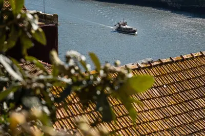 a boat in a body of water with a fence at GuestReady - Oporto Old Town House 2 in Porto