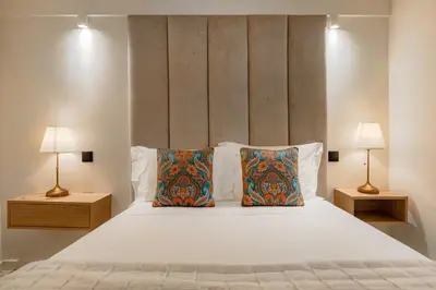 a bedroom with a large white bed with two lamps at Porto Center Duplex | Edifício Terracotta in Porto