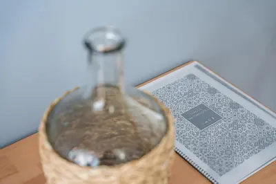 a glass bottle sitting on a table next to a card at GuestReady - Souto Downtown Studios in Porto