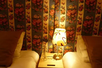 a lamp on a night stand next to a bed at Apartamento Vintage 1 in Porto
