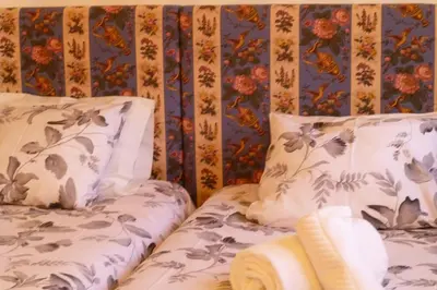 a bedroom with two beds with pillows at Apartamento Vintage 1 in Porto