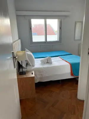 a small bedroom with a bed and a window at Apartamento Vintage 1 in Porto
