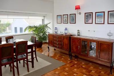 a dining room with a table and a wooden cabinet at Apartamento Vintage 1 in Porto
