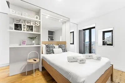 a white kitchen with a sink and a window at GuestReady - Old City Design Apartments in Porto