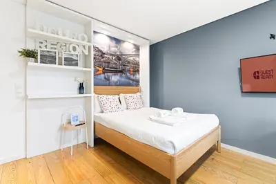 a dining room with a glass table and chairs at GuestReady - Old City Design Apartments in Porto