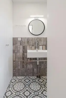 a bathroom with a sink and a mirror at Stylish Studio w/ Charming Terrace by HostWise in Porto