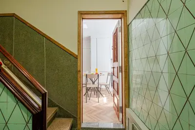 a hallway leading to a dining room with green walls at Stylish Studio w/ Charming Terrace by HostWise in Porto