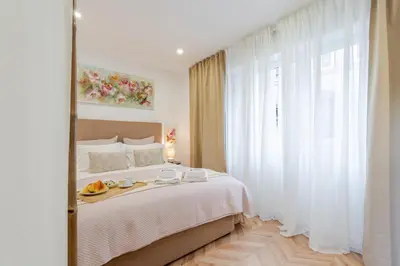 a bedroom with a bed with a tray of fruit on it at Stylish Studio w/ Charming Terrace by HostWise in Porto