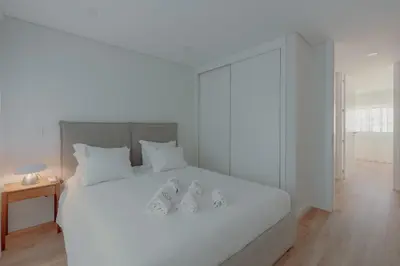 a living room with a flat screen tv on a shelf at Brand New Musas Ap by Best2Stay in Porto