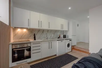 a bedroom with a large white bed and a chair at Yellow House by Best2Stay in Vila Nova de Gaia