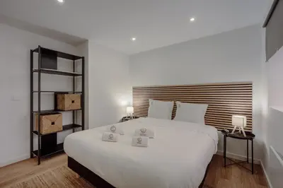a kitchen with white cabinets and a washer and dryer at Yellow House by Best2Stay in Vila Nova de Gaia