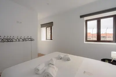 a kitchen with white cabinets and a wooden table at House River View by Best2Stay in Vila Nova de Gaia