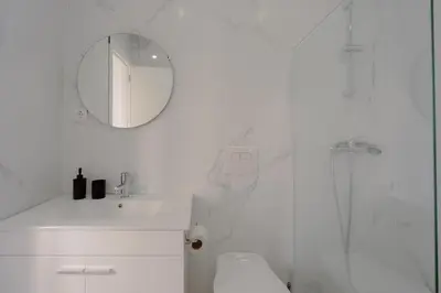 a white bathroom with a sink and a mirror at House River View by Best2Stay in Vila Nova de Gaia
