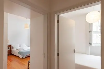 a bedroom with a door leading to a bed at A House With A View - 1st floor in Porto