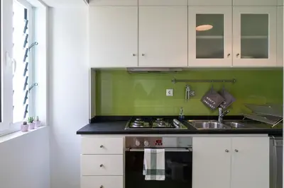 a kitchen with a sink and a stove top oven at A House With A View - 1st floor in Porto