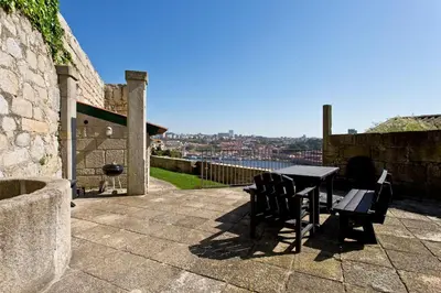 a table and chairs on a patio with a view at A House With A View - 1st floor in Porto