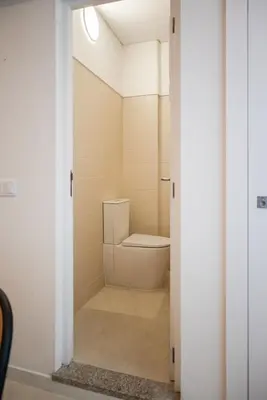 a bathroom with a toilet in a room at Family Porto in Porto
