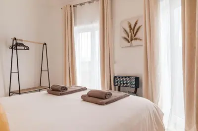 a bedroom with a bed with two towels on it at Family Porto in Porto