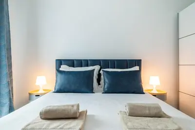 a bedroom with a large bed with blue pillows at Family Porto in Porto