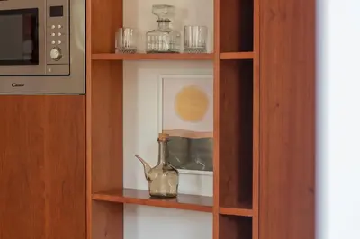 a vase sitting on a shelf next to a microwave at Miragaia Studio w Patio by LovelyStay in Porto