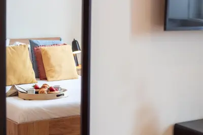 a tray of fruit sitting on a bed at Miragaia Studio w Patio by LovelyStay in Porto