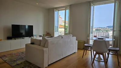 a living room with a white couch with colorful pillows at Pink Lux Apartments in Porto