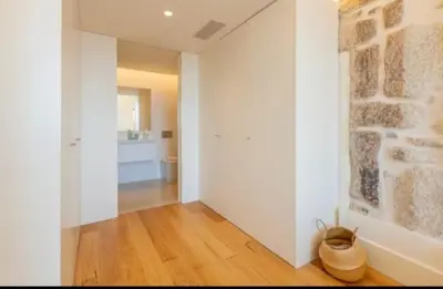a white bedroom with a large bed and a window at Pink Lux Apartments in Porto