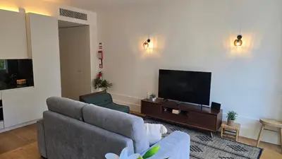 a living room with a couch and a glass table at Pink Lux Apartments in Porto