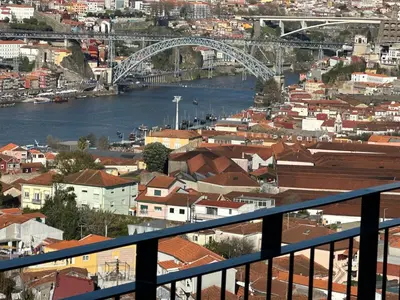 a bedroom with a large white bed and a television at New Douro 908 with parking in Vila Nova de Gaia