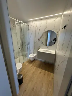 a bathroom with two sinks and a shower and a mirror at New Douro 908 with parking in Vila Nova de Gaia