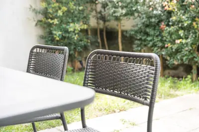 two wicker chairs and a table on a patio at GuestReady - One perfect home near the city centre in Porto