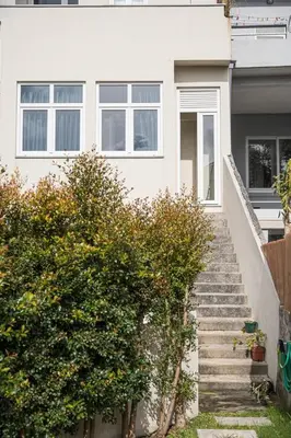 a white house with stairs in front of it at GuestReady - One perfect home near the city centre in Porto