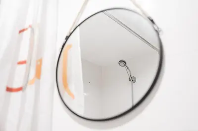 a round mirror hanging on a wall at GuestReady - Oporto Old Town House 1 in Porto