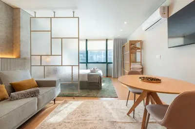 a living room with a couch and a table at DoisPontoZero Campo 24 Agosto in Porto
