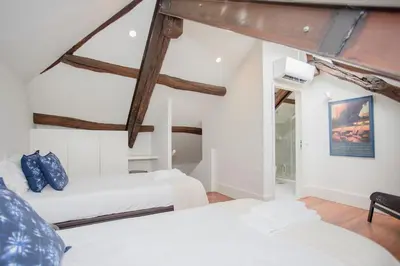 two beds in a room with wooden beams at Liiiving in Porto - Downtown & Riverside Balcony in Porto